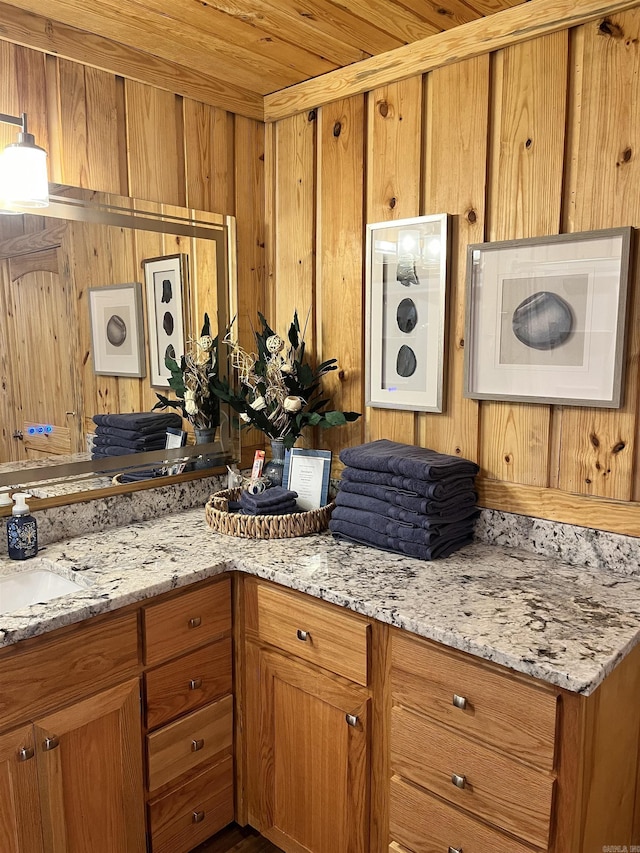 173 Henry Ln, Shirley, AR 72153 - kitchen featuring brown cabinets, wood walls, a sink, light stone countertops, and wood ceiling