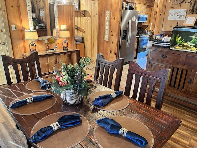 173 Henry Ln, Shirley, AR 72153 - dining room featuring wood walls and light wood-style floors