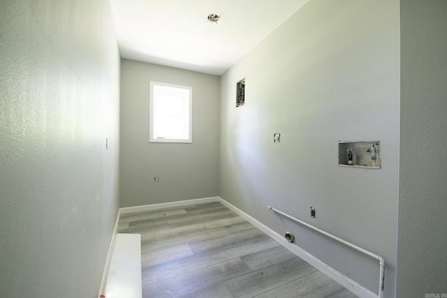 washroom with washer hookup and light hardwood / wood-style floors