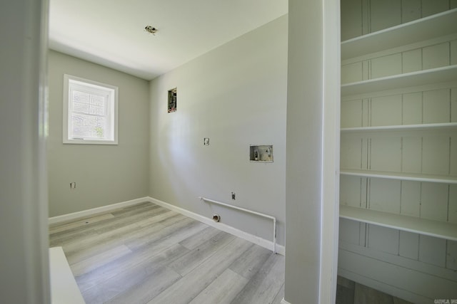 laundry area featuring hookup for a washing machine and light hardwood / wood-style flooring