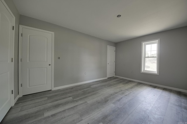 empty room with light hardwood / wood-style flooring