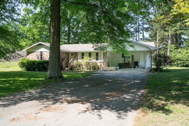 ranch-style home featuring covered porch and a front lawn