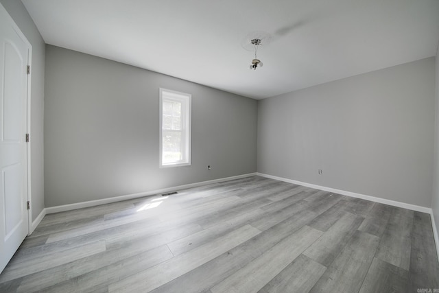 spare room with light hardwood / wood-style flooring