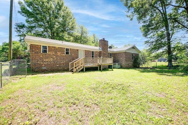 back of house featuring a lawn, central air condition unit, and a wooden deck