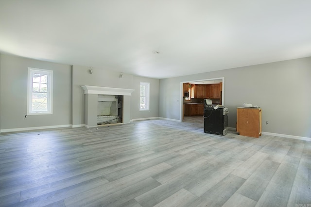 unfurnished living room with light hardwood / wood-style flooring