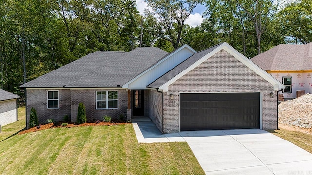 view of front of property with a front yard and a garage