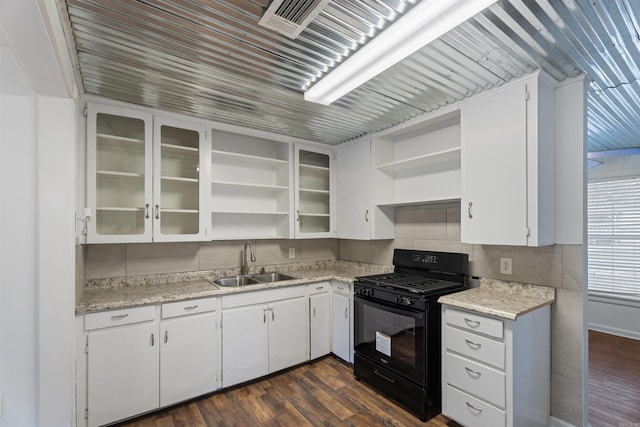 kitchen featuring white cabinets, black gas range, dark hardwood / wood-style floors, and sink