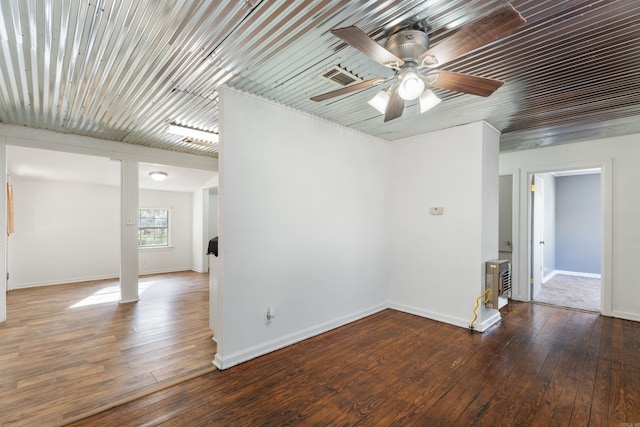 spare room with ceiling fan and dark hardwood / wood-style floors