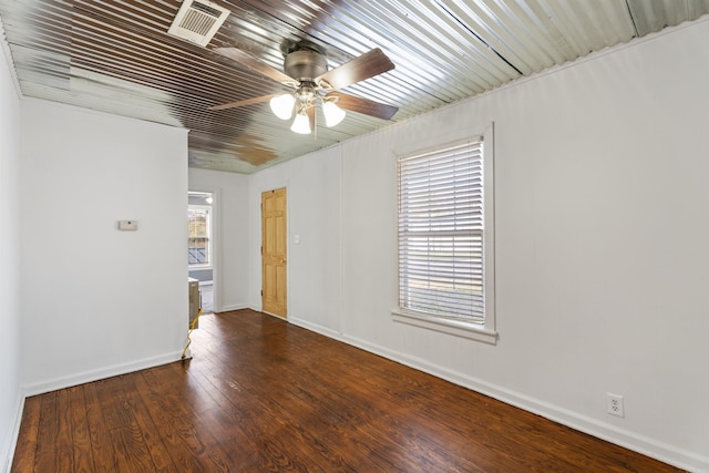 spare room with dark hardwood / wood-style floors and ceiling fan