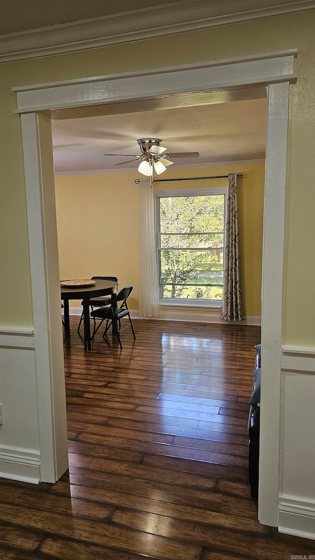 dining room with crown molding, dark hardwood / wood-style floors, and ceiling fan