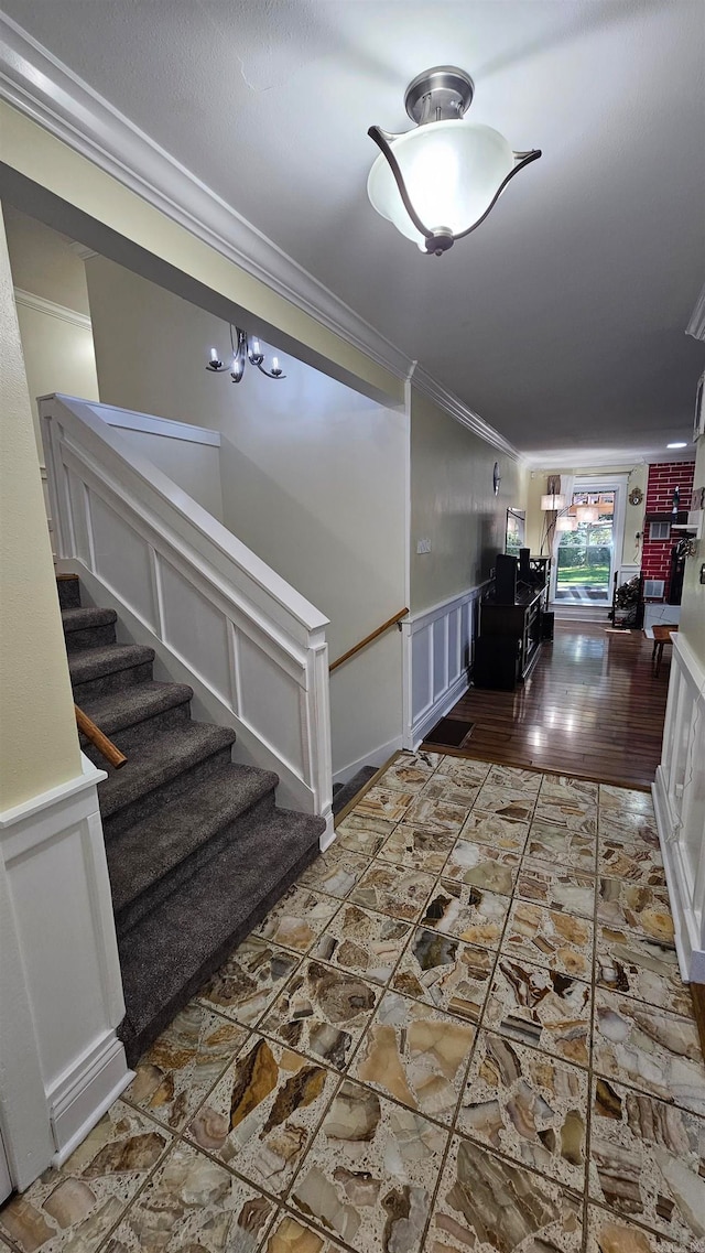 corridor featuring ornamental molding and a notable chandelier