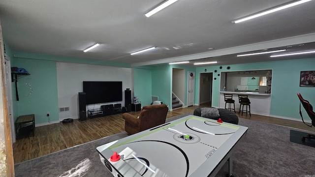 playroom with a textured ceiling and dark hardwood / wood-style flooring