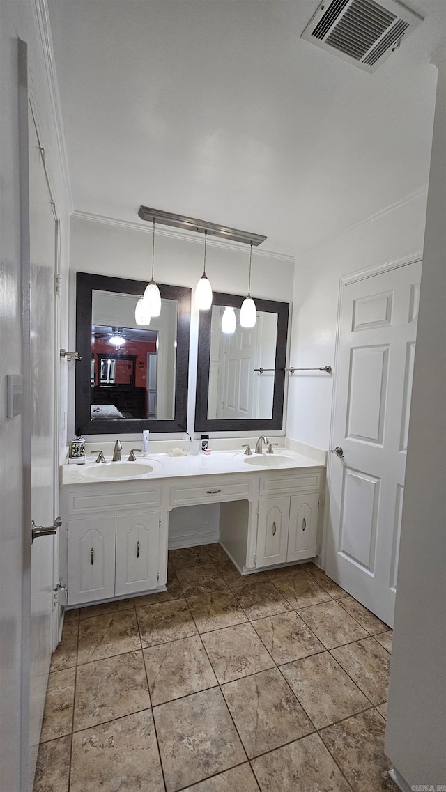 bathroom with ornamental molding, vanity, and tile patterned flooring