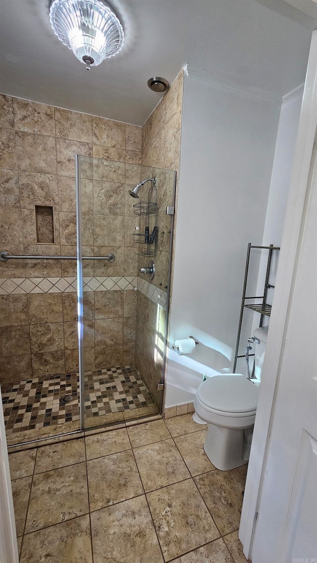 bathroom with tile patterned floors, toilet, and walk in shower