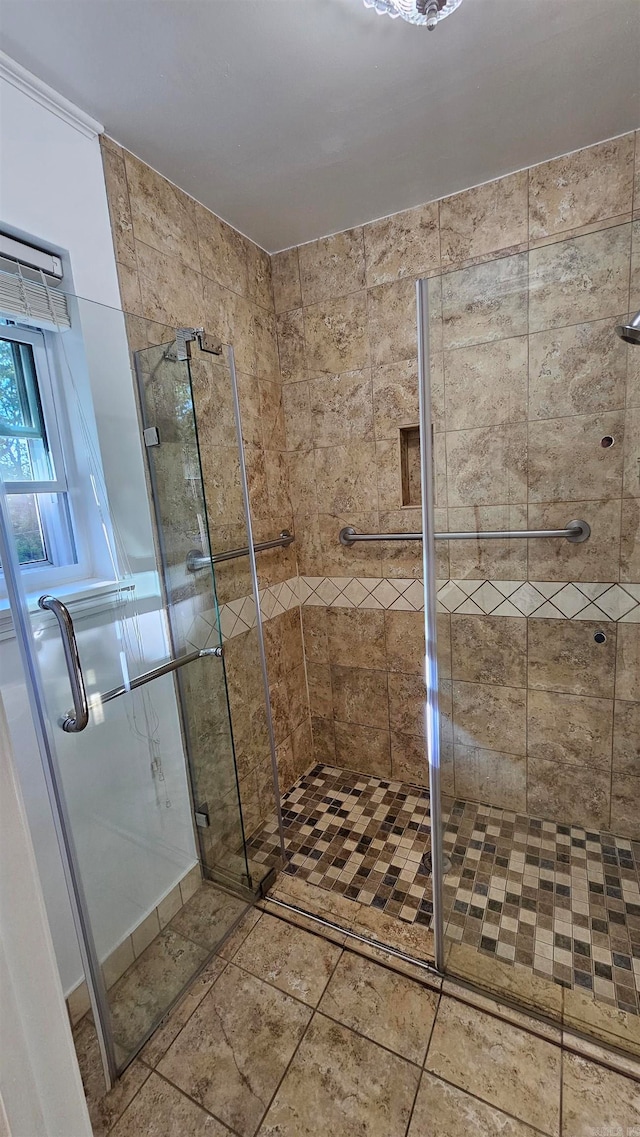 bathroom featuring a shower with door