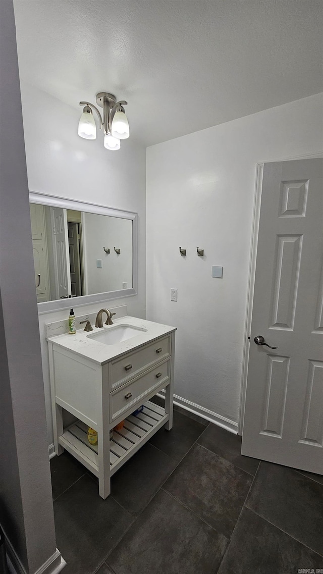 bathroom with vanity and a chandelier