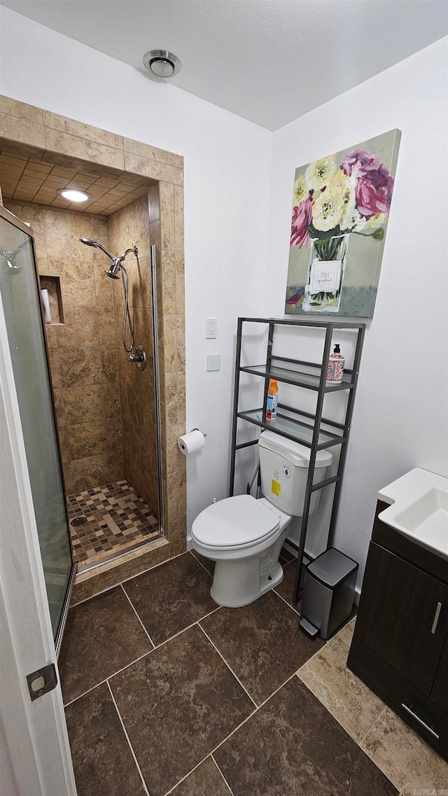 bathroom featuring walk in shower, vanity, and toilet