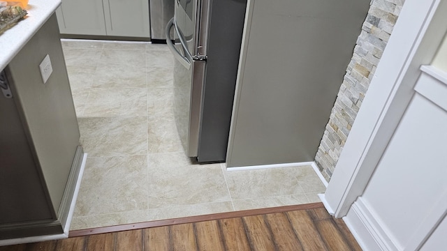 exterior details with gray cabinetry and stainless steel fridge