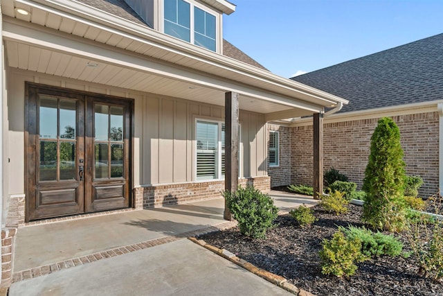 doorway to property featuring a porch and french doors