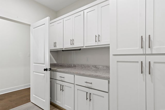 kitchen featuring hardwood / wood-style floors and white cabinets