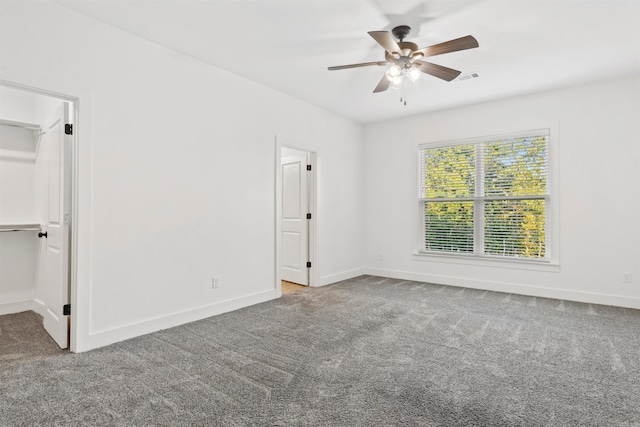 carpeted spare room with ceiling fan