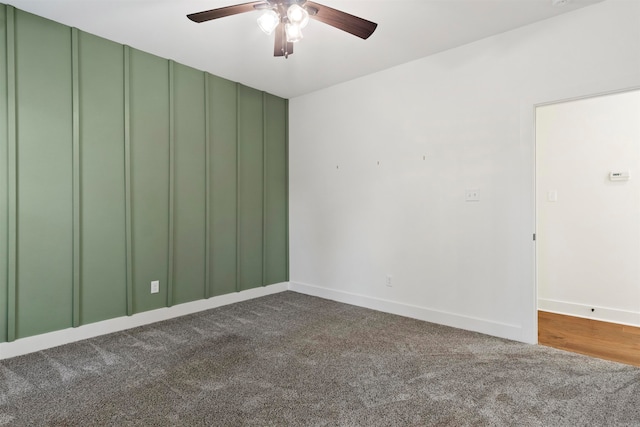 unfurnished room featuring dark colored carpet and ceiling fan