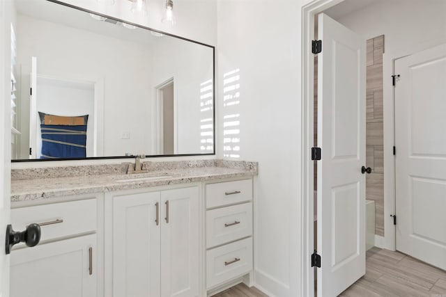 bathroom featuring hardwood / wood-style floors and vanity