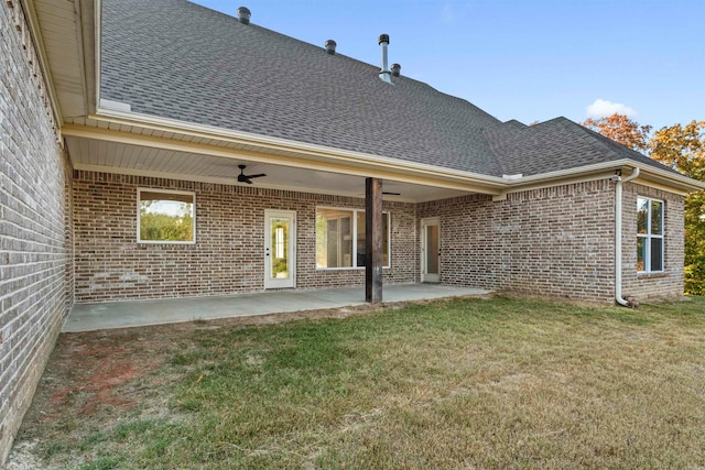 rear view of house with a lawn, ceiling fan, and a patio area