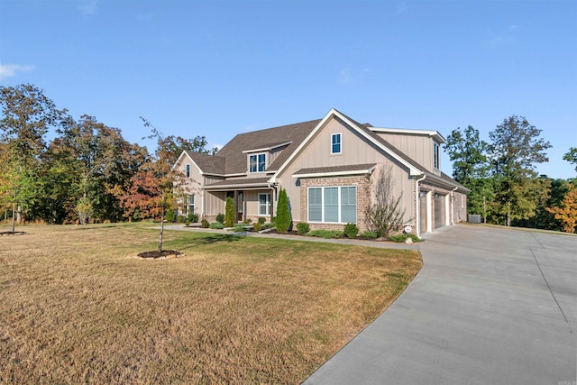 view of front of property featuring a front yard and a garage