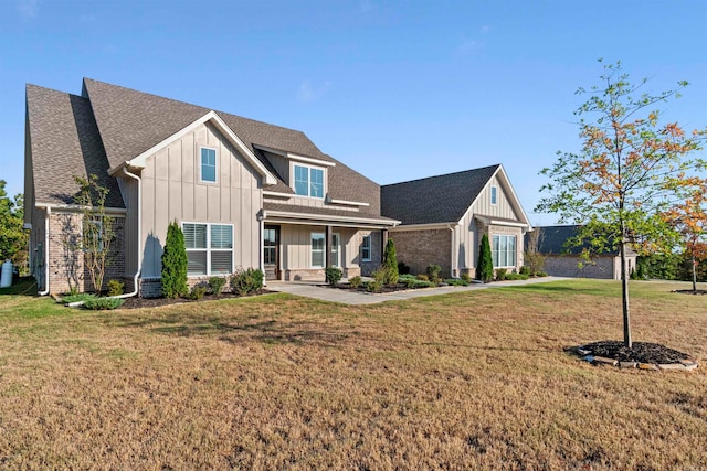 view of front of home with a porch and a front yard