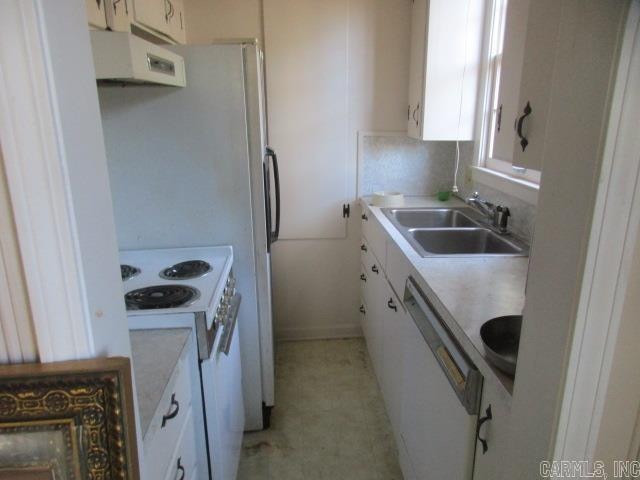 kitchen featuring sink, white cabinets, extractor fan, and white appliances