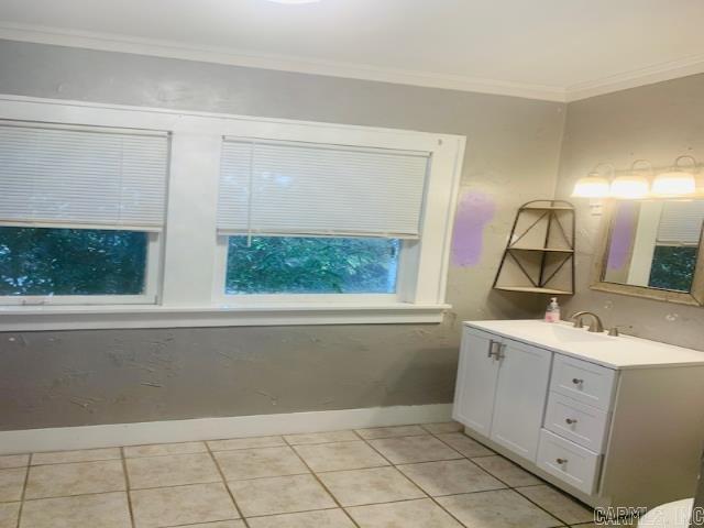 bathroom with tile patterned flooring, vanity, and ornamental molding