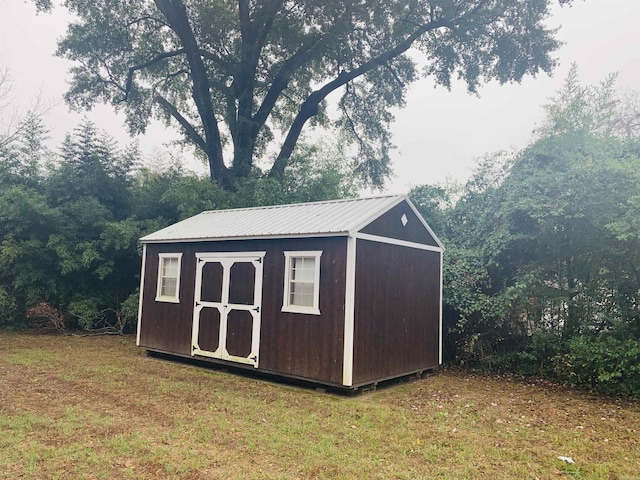 view of outbuilding with a yard