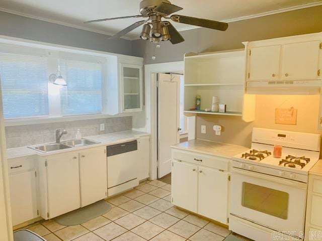 kitchen with white appliances, sink, light tile patterned floors, ornamental molding, and white cabinetry