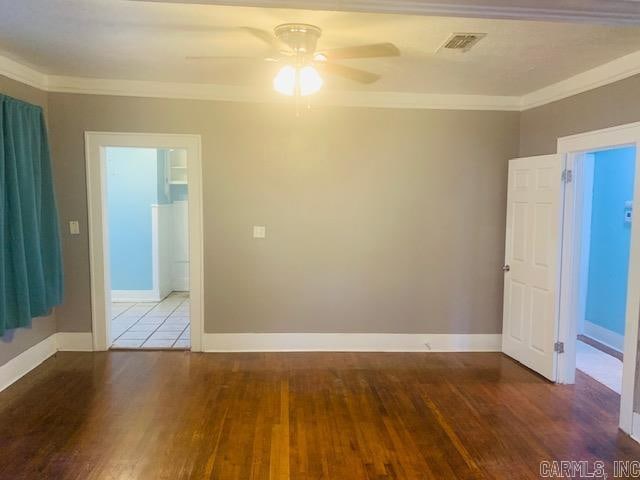 unfurnished room with ceiling fan, wood-type flooring, and ornamental molding