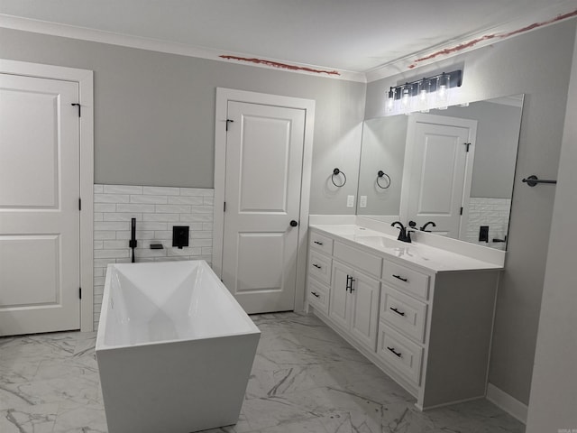 bathroom featuring a soaking tub, marble finish floor, crown molding, and vanity