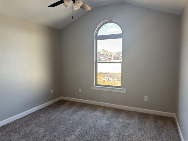 unfurnished room with vaulted ceiling, ceiling fan, carpet, and baseboards