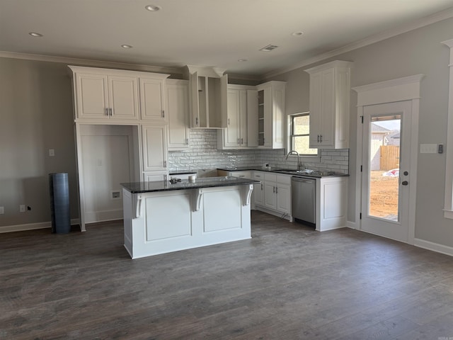 kitchen with tasteful backsplash, visible vents, dark countertops, a center island, and stainless steel dishwasher