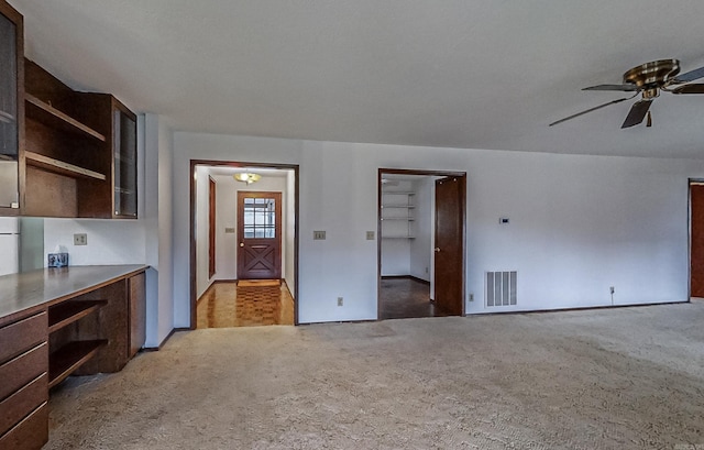 interior space featuring carpet flooring and ceiling fan