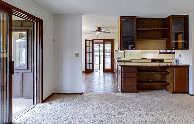 kitchen with ceiling fan and carpet