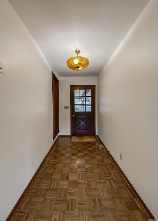 entryway with dark parquet floors