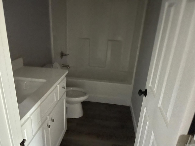 full bathroom featuring hardwood / wood-style floors, vanity, toilet, and shower / tub combination