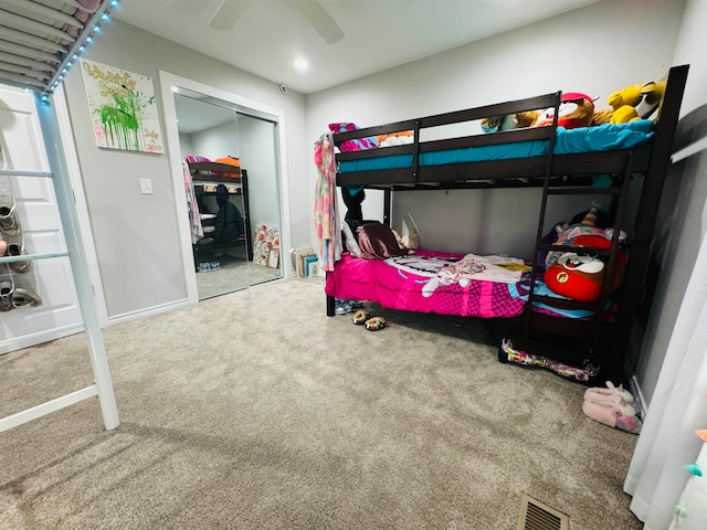 bedroom with carpet flooring, ceiling fan, and a closet