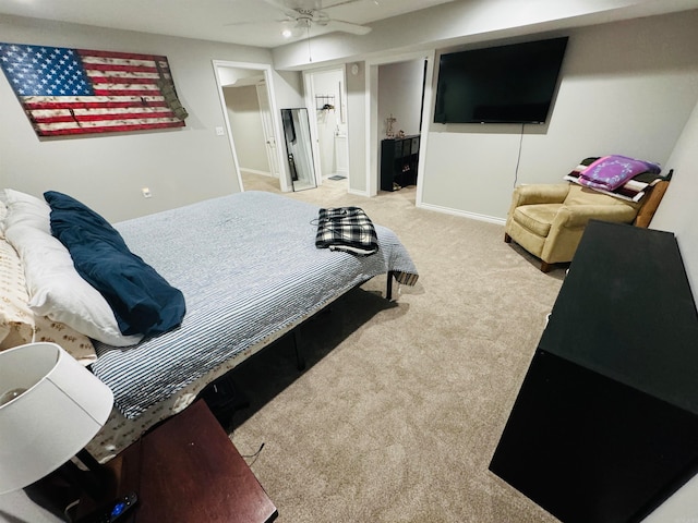 carpeted bedroom with connected bathroom and ceiling fan