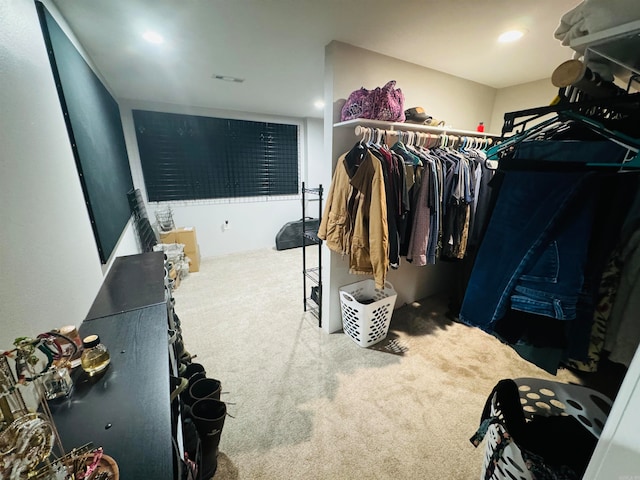 walk in closet featuring carpet flooring