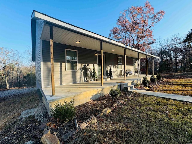 rear view of property featuring a porch