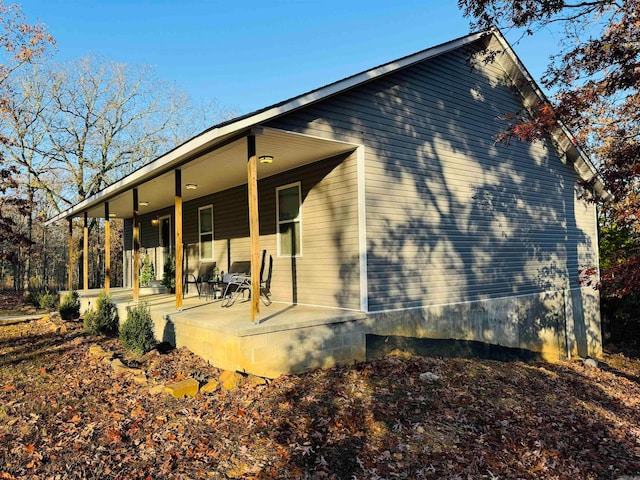 back of property featuring a porch