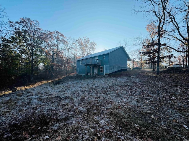 rear view of property featuring a deck