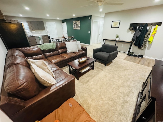 living room featuring light hardwood / wood-style flooring and ceiling fan