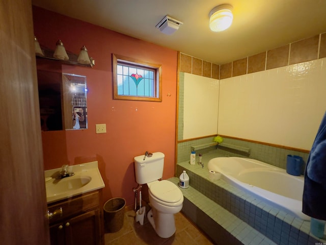 bathroom featuring tile patterned flooring, vanity, toilet, and tiled tub